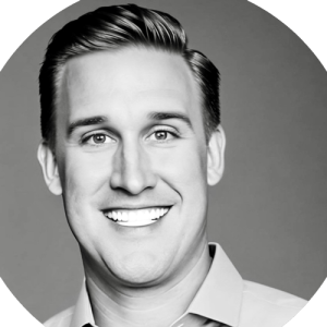 a black and white photograph of Brian's headshot smiling into the camera